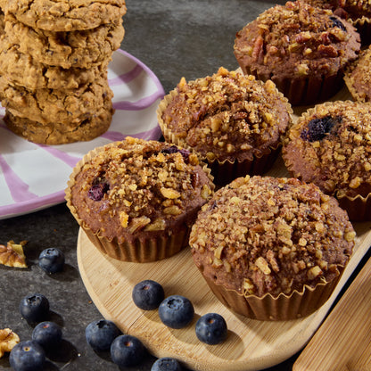 A selection of natural snack muffins and cookies on a plate with blueberries.