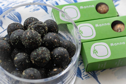 Energy balls with a green packaging in the background.