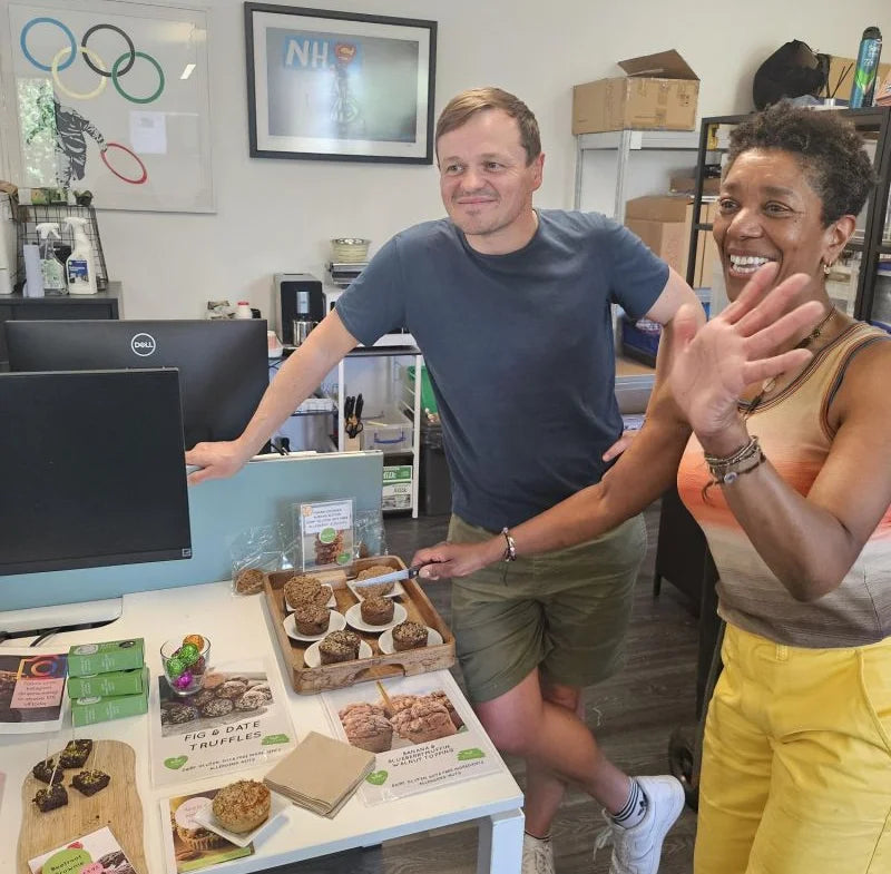 Photo of Vanessa and a team member in a kitchen preparing snacks.